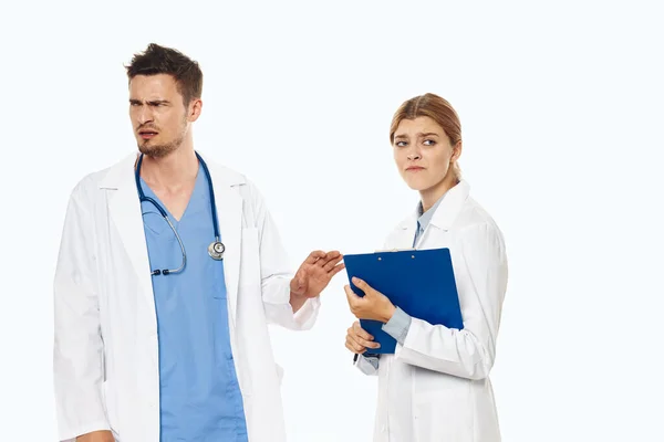 Young angry doctors in studio, isolated background.