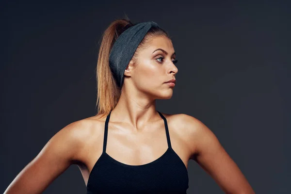 young sporty woman bodybuilder posing in studio