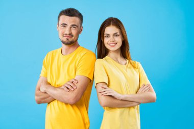 Stüdyoda izole edilmiş arka planda poz veren tişörtlü güzel bir çift.