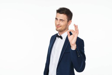Young   man  showing ok   in studio,  isolated  background