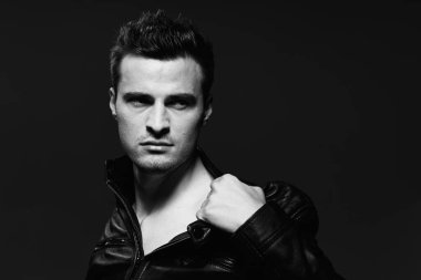 Stüdyo çekimi. Karanlık arka planda genç ve vahşi bir adamın portresi.  