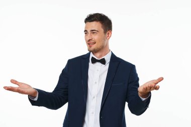 Young   man  showing something   in studio,  isolated  background