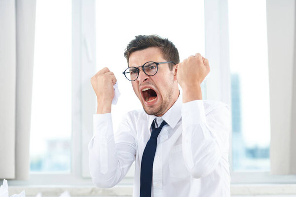 Young handsome businessman is stressed in office