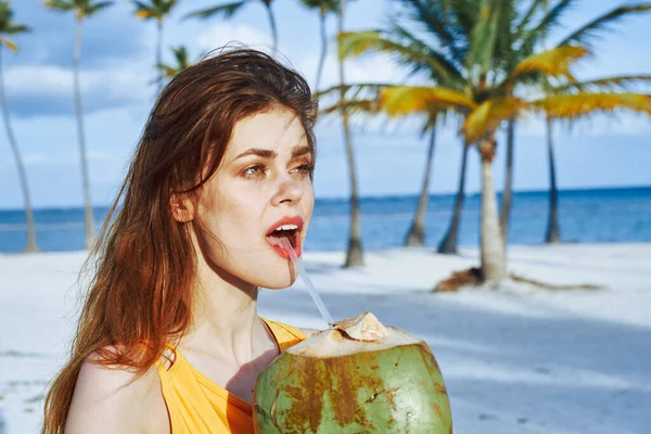 Young beautiful woman  with cocktail on beach