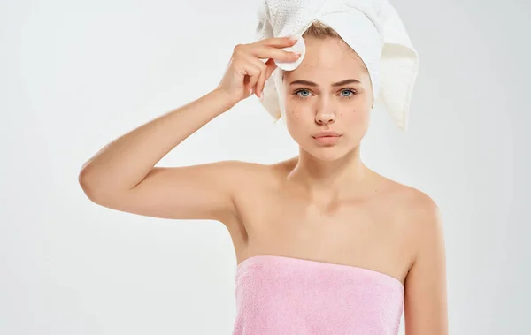 Young beautiful woman  with towel on head in studio