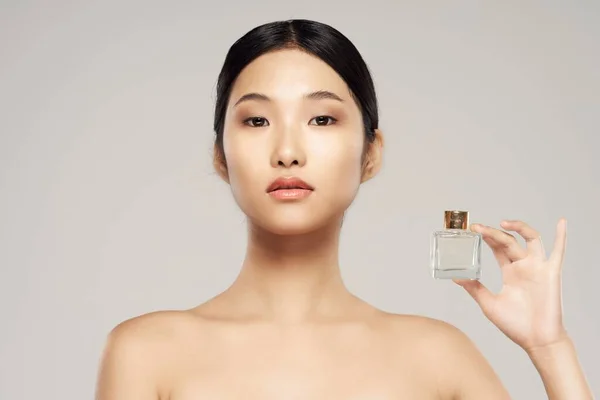 young beautiful  asian woman with perfume