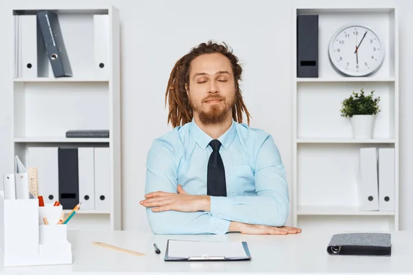 目を閉じてオフィスに座っている若いビジネスマン — ストック写真