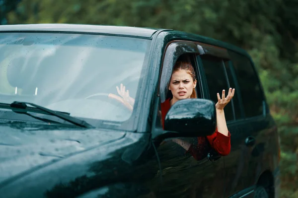 Young beautiful angry   woman driver in the car