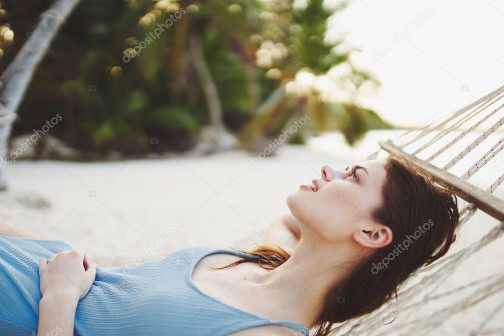 Young beautiful woman relaxing in hammock 