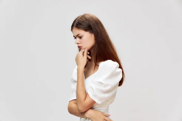 Woman with pensive expression look down white dress cropped view — Stock Photo, Image