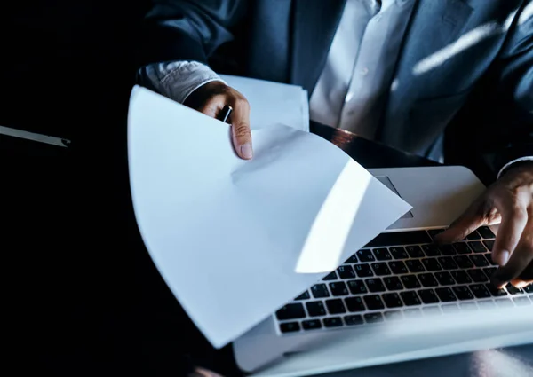 business man in suit in front of laptop with book work communication technology