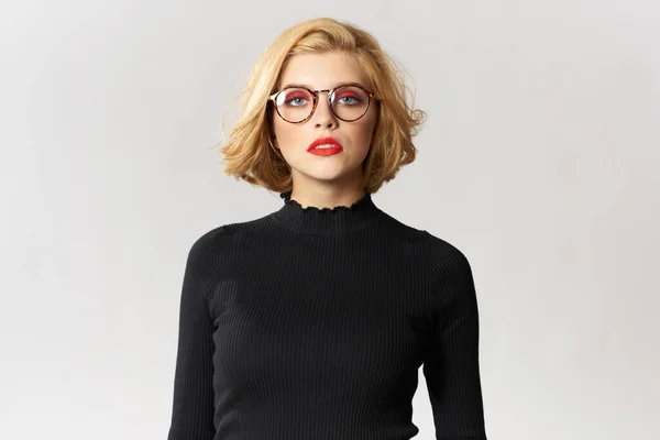 Blonde girl with glasses red lips black blouse cropped view glamor light background studio — Stock Photo, Image
