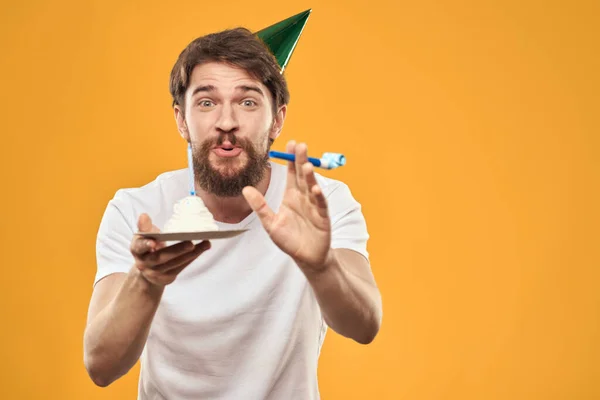 Születésnapi fiú egy sapka torta szórakoztató sárga háttér party — Stock Fotó
