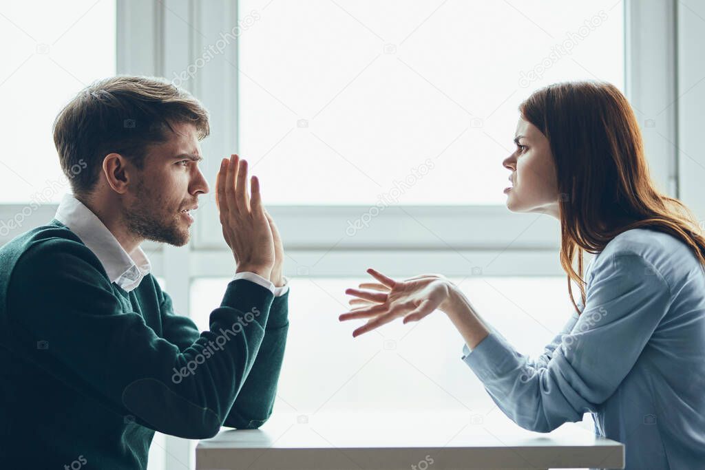 Man and woman at the table sport conflict gesture 