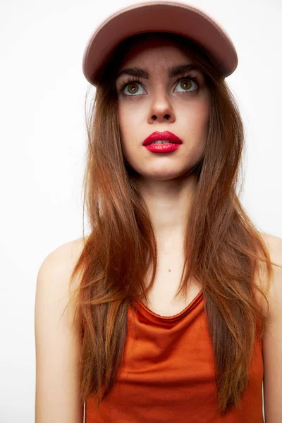 Woman with a cap Look up surprise of the model on her head red sundress — Stock Photo, Image