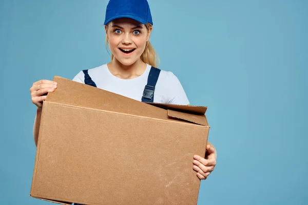 Woman working form box in hands packing delivery service blue background