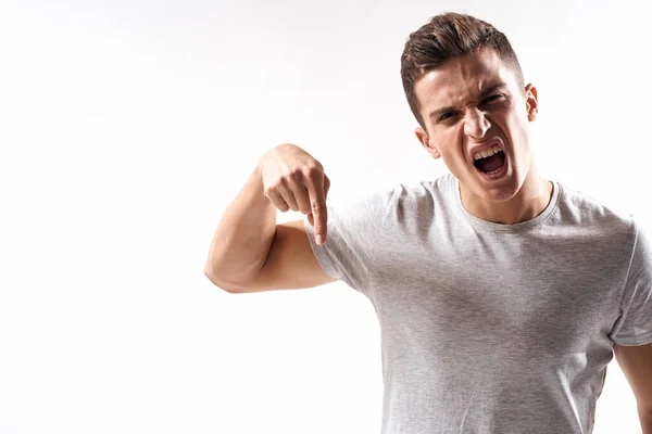 Sporty man in white t-shirt on a light background gesturing with his hands cropped view Copy Space — Stock Photo, Image