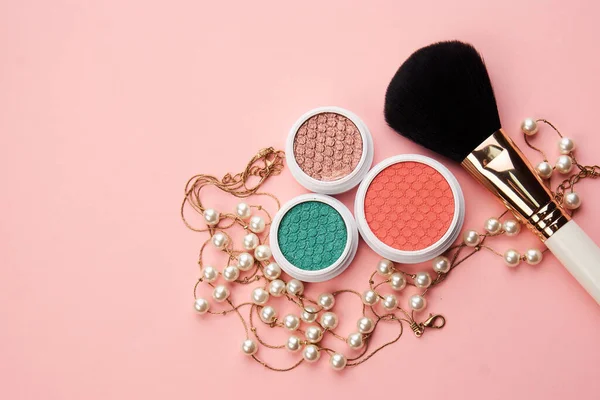 Eyeshadows and makeup brushes on a pink background Copy Space top view — Stock Photo, Image