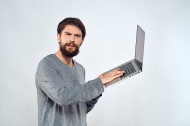 Elinde dizüstü bilgisayarı olan sakallı bir adam internet iletişimi teknolojisi ışık arka planı