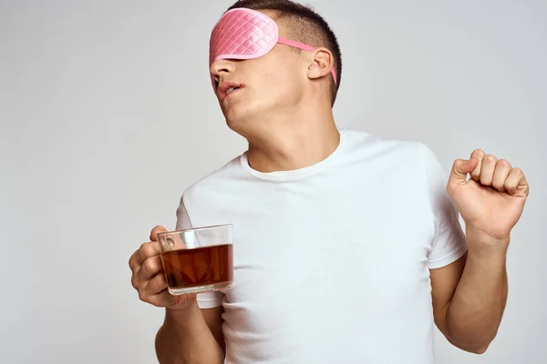 ピンクの睡眠マスクに茶色いカップを手にしたハンサムな男が — ストック写真