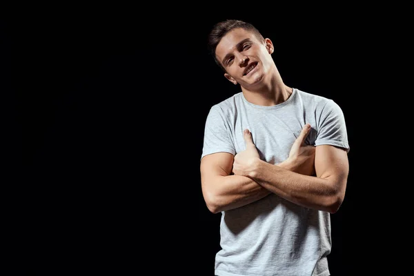 Handsome man in white t-shirt on black background inflated arm muscles sport model cropped view Copy Space — Stock Photo, Image