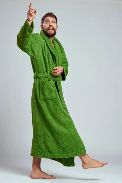 Emotional man in a green robe on a light background in full growth fun emotions model — Stock Photo, Image