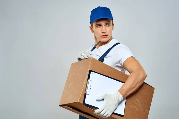 Man worker with box in hands delivery loading service packing service