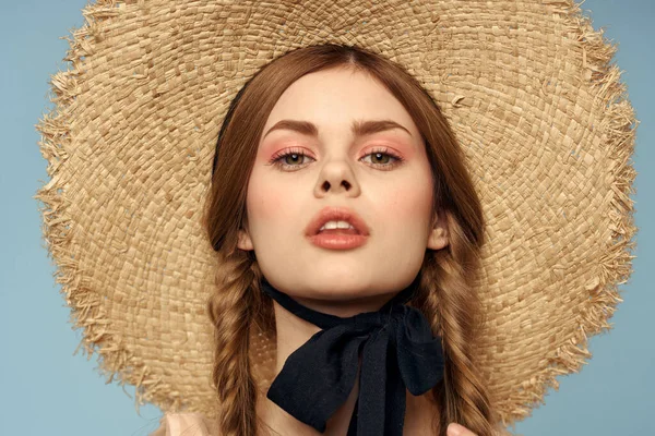 Hasır şapkalı kız portresi yakın çekim at kuyruğu eğlenceli kızıl saçlı mavi arka plan