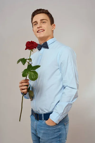 Romantic man with red rose and light shirt pants suit — Stock Photo, Image