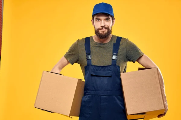 作業員男性宅配ボックス包装書類黄色の背景 — ストック写真