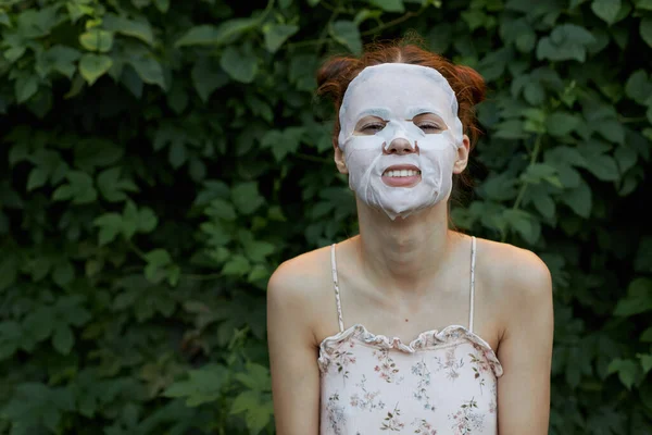 Ritratto di una donna Maschera antirughe Sorriso abbagliante taglio di capelli vestito ringiovanimento lascia sullo sfondo — Foto Stock