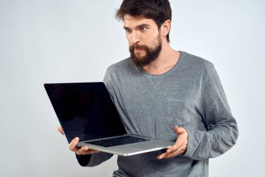 Gri kazaklı bir adam dizüstü bilgisayarlı. Yaşam tarzı teknoloji iletişimi internet işi yapıyor.
