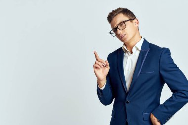 Gözlüklü bir iş adamı mavi takım elbiseli resmi ışık arkaplanı kesmiş.