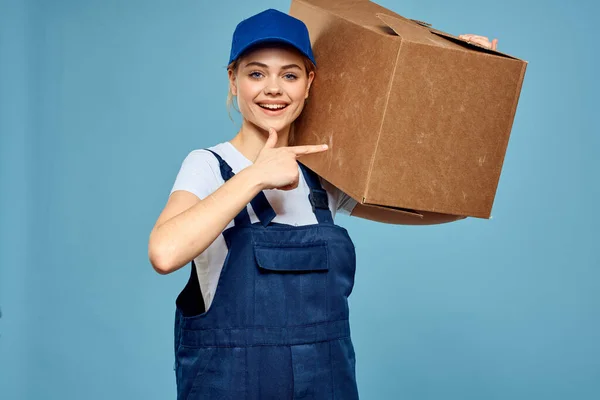 Woman working form box in hands packing delivery service blue background