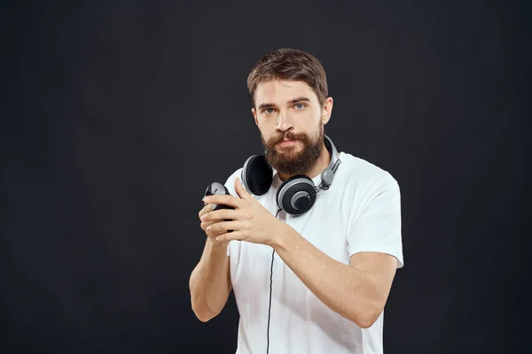 Man with joystick in hands headphones technology leisure game lifestyle dark isolated background — Stock Photo, Image