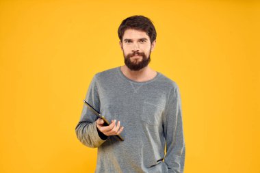 Elinde tablet olan duygusal bir adam internet aygıtı yaşam tarzı sarı arka plan