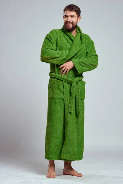 Emotional man in a green robe on a light background in full growth fun emotions model — Stock Photo, Image