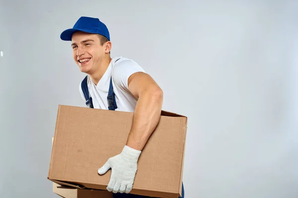 Man worker with box in hands delivery loading service packing service