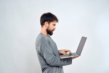 Elinde dizüstü bilgisayarı olan sakallı bir adam internet iletişimi teknolojisi ışık arka planı