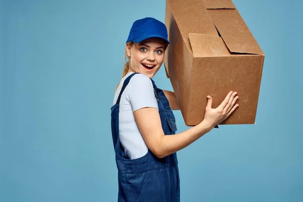 Woman working form box in hands packing delivery service blue background