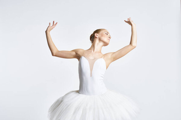 Ballerina in tutu performing dance exercise. High quality photo