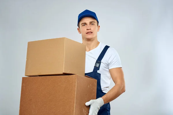 working man in uniform with boxes in his hands delivery loader lifestyle