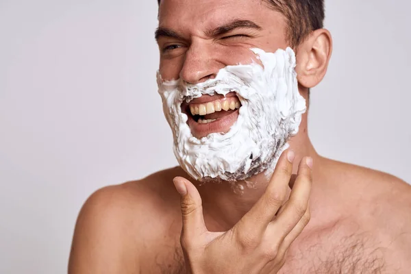 Handsome man with white shaving foam on his face and clean skin with razor grooming bare shoulders — Stock Photo, Image