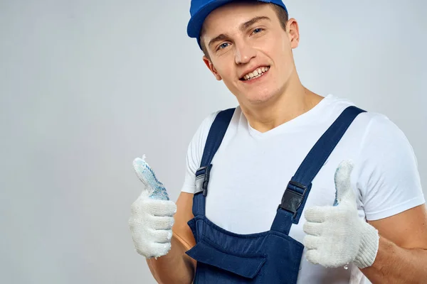 Man worker in forklift uniform delivery service light background