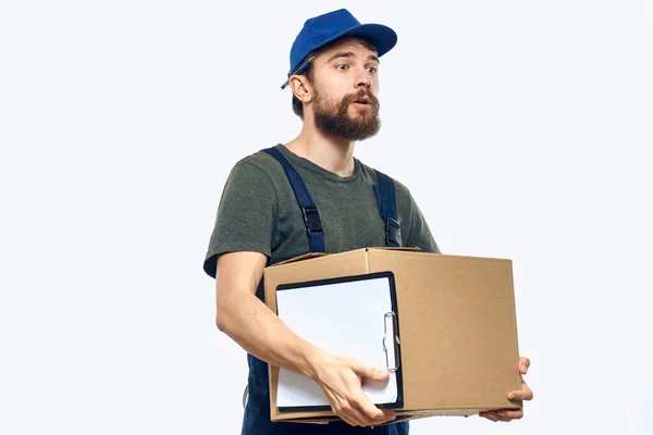 Working male courier with box in hand documents delivery service light background — Stock Photo, Image