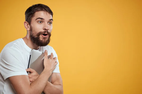 emotional man with laptop on yellow background gesturing with hands cropped view Copy Space