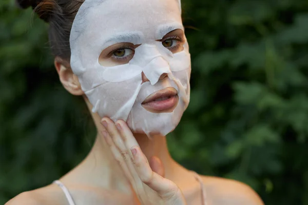 Nice woman anti-aging mask Keep your hand close to your face and clean skin skin care