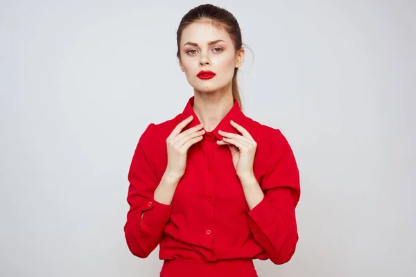 Retrato de una mujer con labios rojos en una camisa sobre un fondo claro recortado ver modelo maquillaje peinado — Foto de Stock