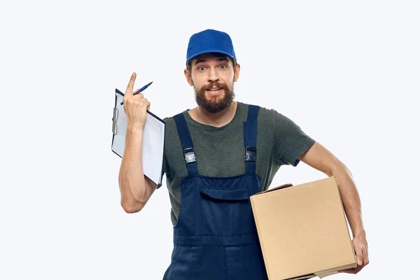 Man in working uniform box delivery loader courier light background — Stock Photo, Image