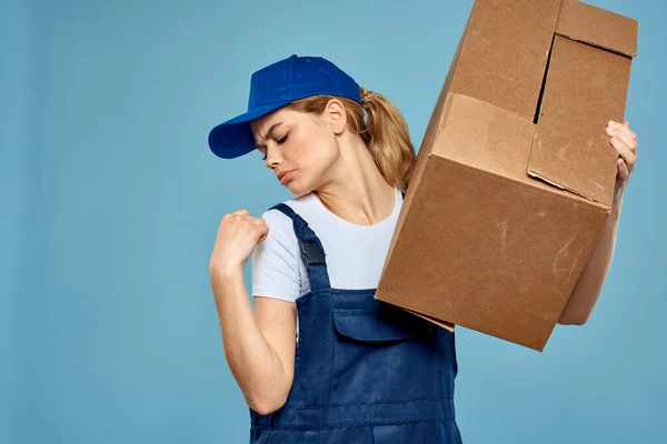 Woman working form box in hands packing delivery service blue background